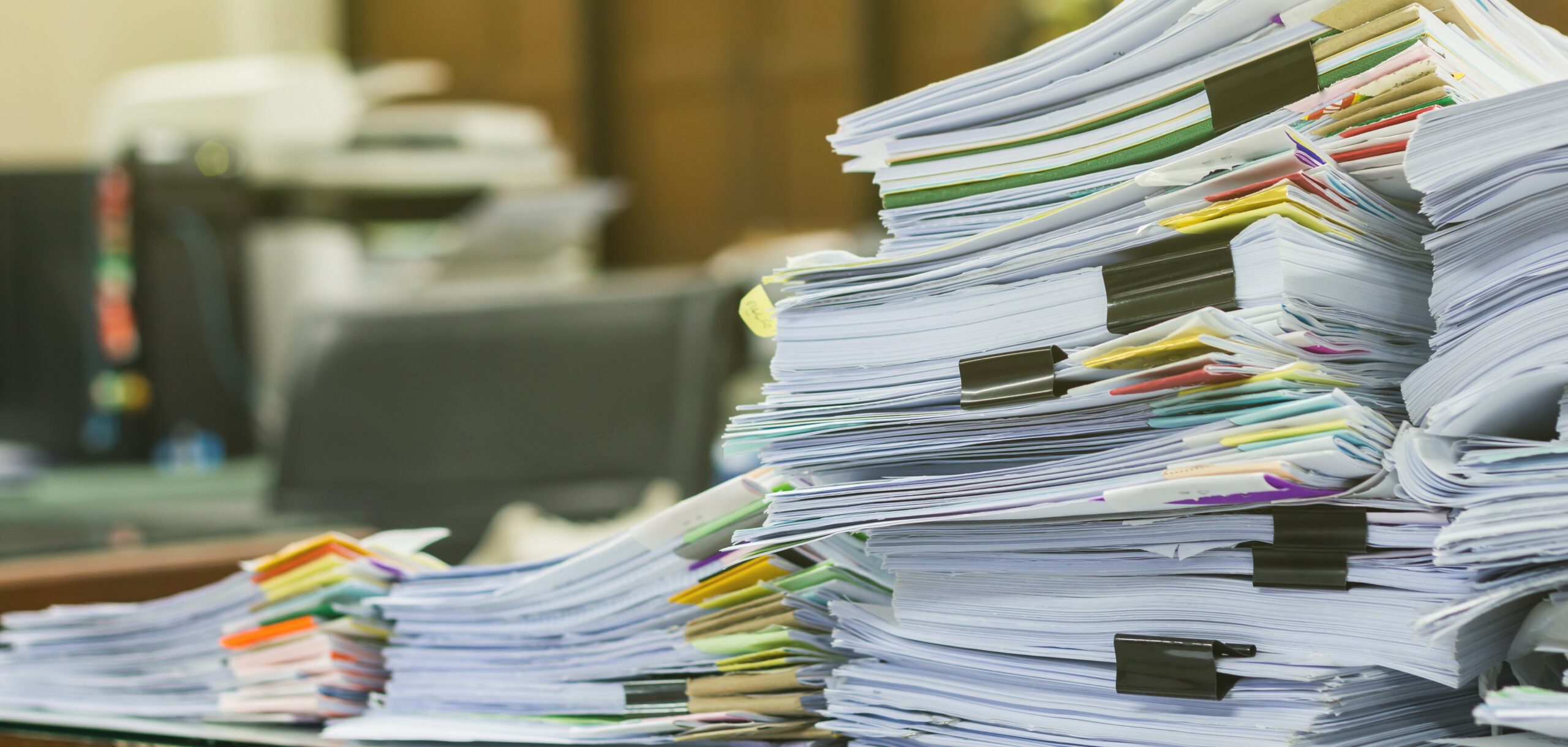 Pile of documents on desk at workplace