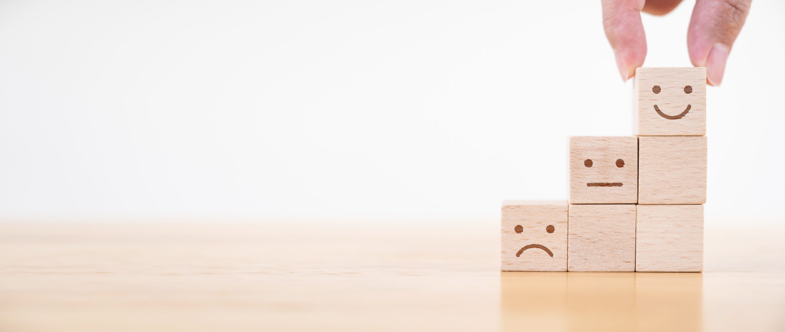 Hand chooses smiley face growth on wood block cube, The best excellent business services rating customer experience, Satisfaction survey concept. Panoramic image
